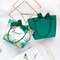 Bolsas de papel del verde lima de la impresión de la planta tropical con las manijas de la cinta